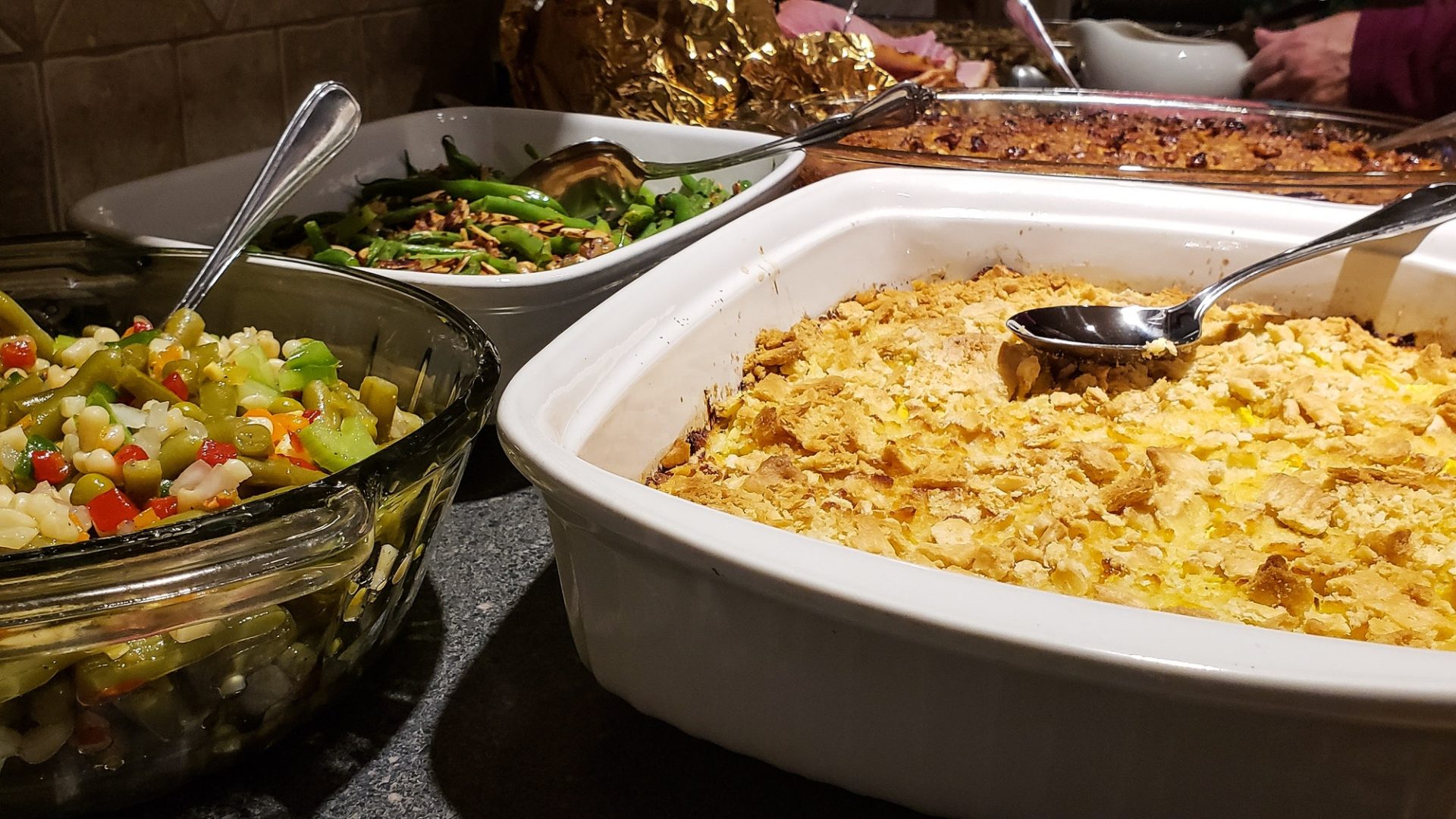 Thanksgiving dinner served at holiday dinner party featuring fall foods with casseroles.