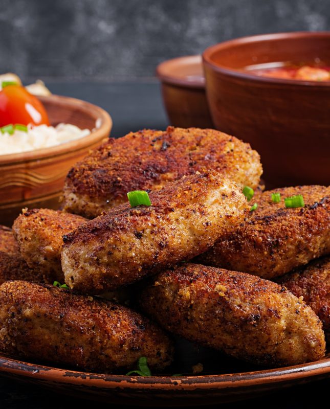 Juicy delicious meat cutlets on a dark table. Russian cuisine.