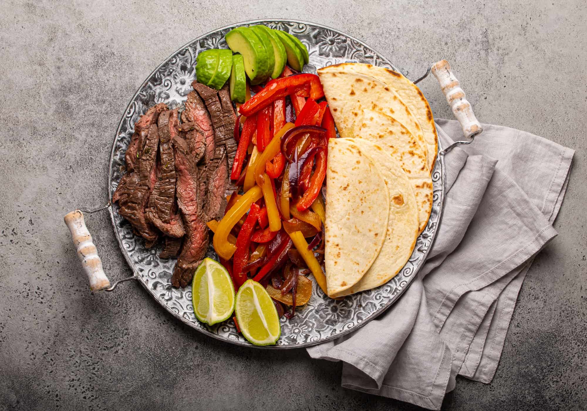 Mexican dish Beef fajitas with tortillas from above