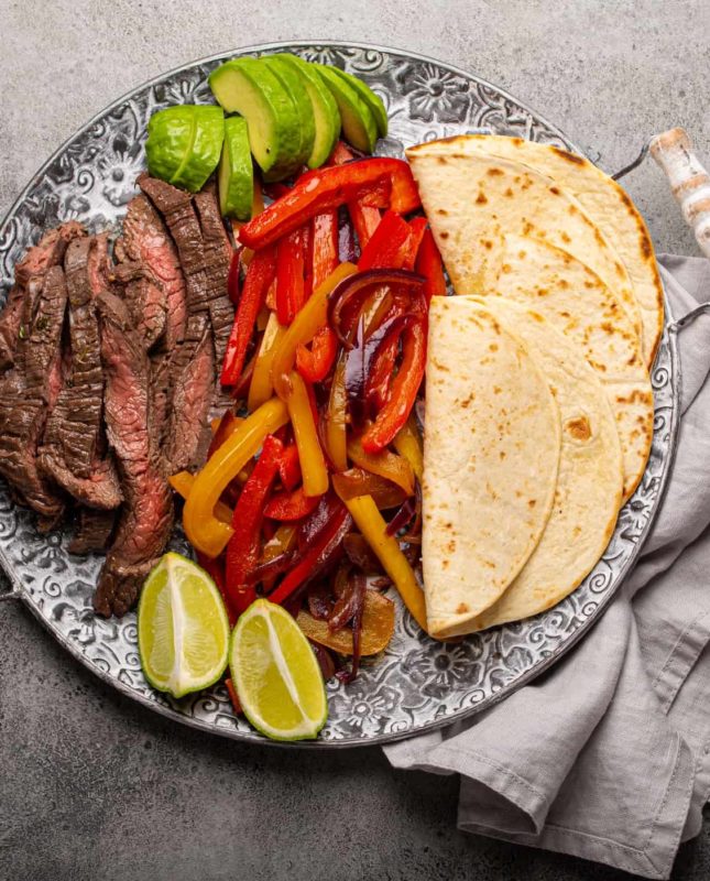 Mexican dish Beef fajitas with tortillas from above
